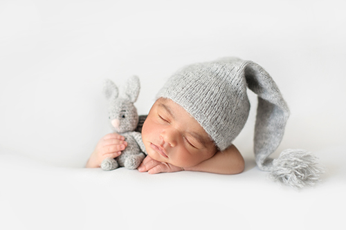 cute-infant-sleeping-with-grey-crocheted-hat-with-toy-rabbit_2.jpg